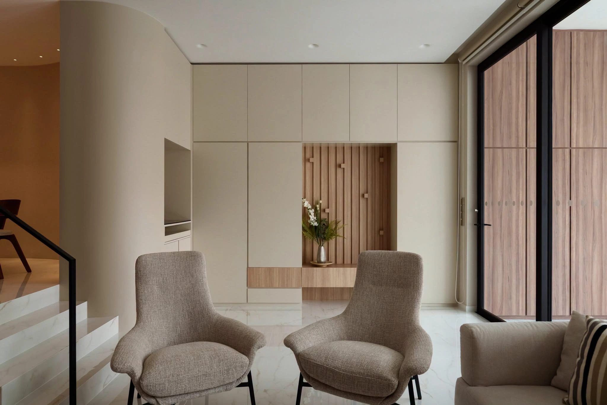A sophisticated room corner with warm chocolate brown walls and a classic wooden side table