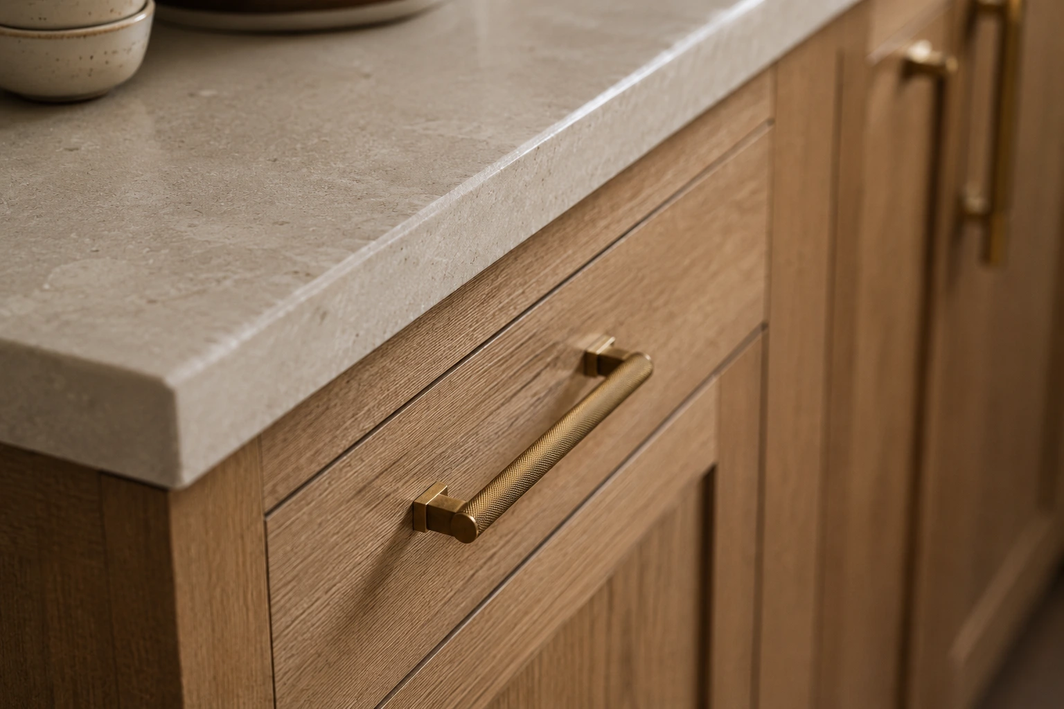 Timeless kitchen material harmony with warm stone countertops and custom oak cabinet details
